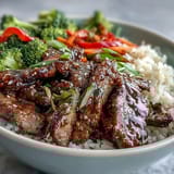 Glossy, rich teriyaki sauce coats tender beef slices and broccoli on steamed rice.