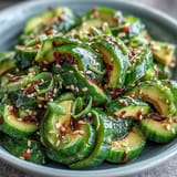 Creamy avocado meets crisp smashed cucumbers in a nutty sesame salad, ideal for light lunches or healthy sides.  