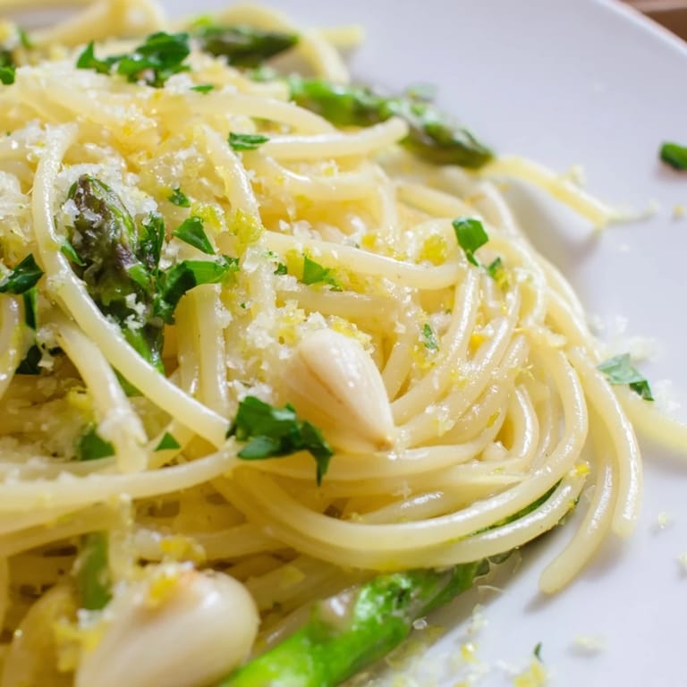Golden roasted garlic and asparagus are tossed with al dente spaghetti, olive oil, and Parmesan, creating a simple, spring-inspired vegetarian main dish.