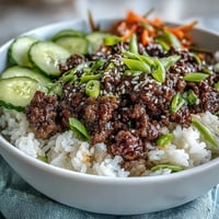 Bright and colorful Korean Ground Beef Bowl with seasoned ground beef, fluffy rice, and vibrant pickled carrots, cucumbers, and radishes.