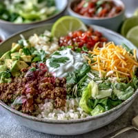 Freshly cooked ground turkey seasoned with chili and cumin, spooned over fluffy white rice in a colorful bowl.