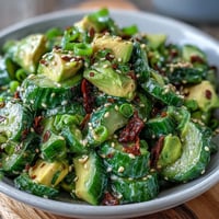Fresh smashed cucumber and avocado salad with sesame dressing, vibrant and refreshing for summer meals.  